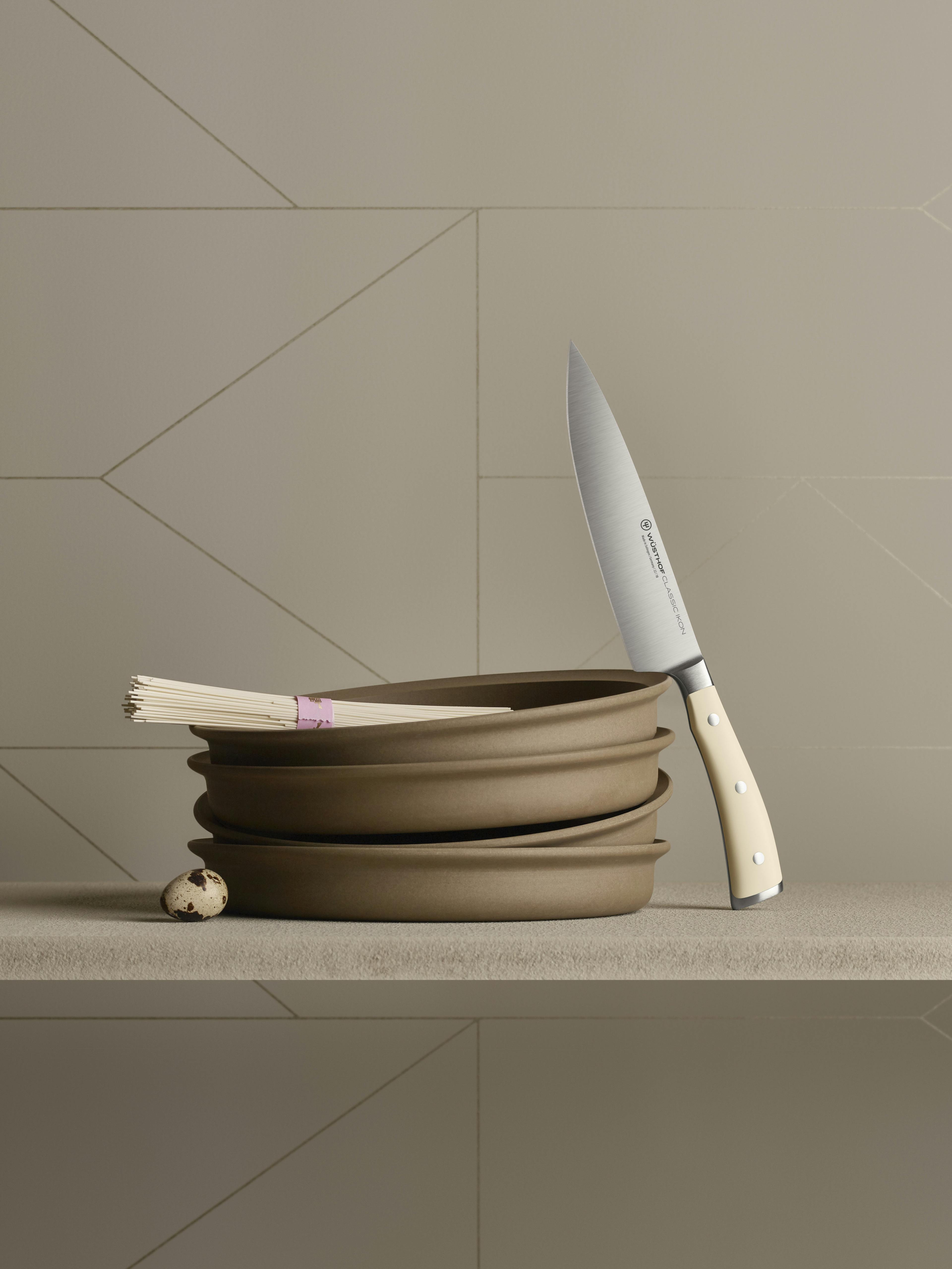 Classic Ikon Chef's Knife next to terracotta bowls