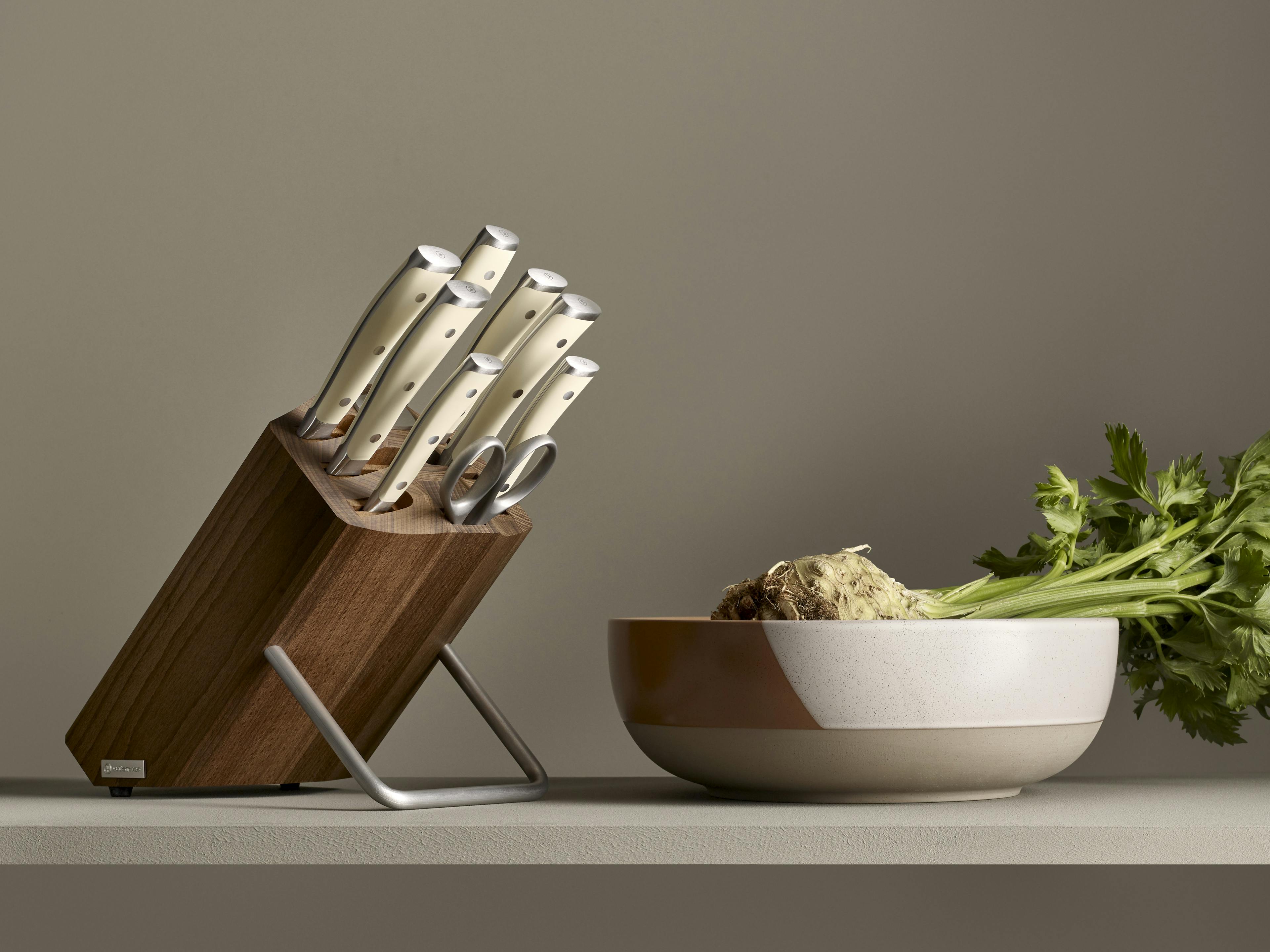 Classic Ikon Creme 9 Piece Knife Set next to bowl of celery